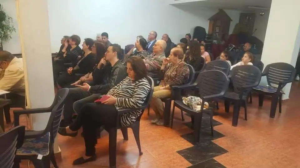 The congregation seated and listening attentively during a Sunday service in Nazareth